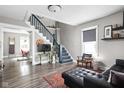 Inviting living room features stairs, plush seating, and ample natural light at 4429 Crittenden Ave, Indianapolis, IN 46205