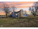 Beautifully renovated home featuring a stone chimney and sprawling front yard, ideal for outdoor activities at 4844 N 700 W, McCordsville, IN 46055
