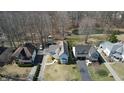 An aerial view of a lovely home with beautiful landscaping and a pond surrounded by mature trees at 5014 Melbourne Rd, Indianapolis, IN 46228