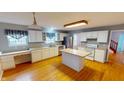 Spacious kitchen featuring white cabinets, stainless steel appliances, and a functional island at 5014 Melbourne Rd, Indianapolis, IN 46228