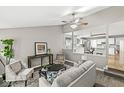 Inviting living room with neutral colors, open to kitchen and dining room creating an open feel at 5014 Melbourne Rd, Indianapolis, IN 46228