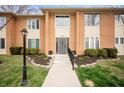 Inviting brick exterior featuring a well-lit walkway leading to the front door at 505 W Hunters Dr # D, Carmel, IN 46032