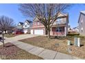 Two-story home with brick and siding exterior, three-car garage, and sidewalk at 5402 Basin Park Dr, Indianapolis, IN 46239