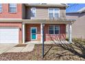 Inviting front porch with brick accents, white columns, and turquoise front door at 5402 Basin Park Dr, Indianapolis, IN 46239