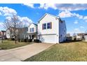 Well-kept, two-story home featuring a two-car garage, tidy landscaping and a blue sky background at 5622 Skipping Stone Dr, Indianapolis, IN 46237