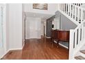 Inviting foyer featuring hardwood floors and a staircase, leading to the upper level at 5855 Dapple Trce, Indianapolis, IN 46228