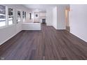 Bright living area with new hardwood flooring and seamless access to the kitchen at 639 S Alpha Ave, Brownsburg, IN 46112