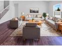Bright living room featuring modern furniture, a stylish rug, and large windows offering plenty of natural light at 6812 W Wintergreen Ct, McCordsville, IN 46055