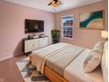 Comfortable bedroom with a ceiling fan, a large window, and stylish decor at 6830 Shooting Star Dr, Whitestown, IN 46075