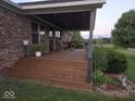 Cozy covered porch with wooden decking and steps, offering a relaxing outdoor space with seating at 7152 Old Morgantown Rd, Martinsville, IN 46151