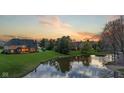 Gorgeous home with a lake view, well-maintained lawn, and plenty of trees at 7357 Windridge Way, Brownsburg, IN 46112