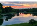 Beautiful lake view with mature trees and a well manicured lawn at 7357 Windridge Way, Brownsburg, IN 46112