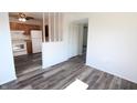 Bright living room with sleek wood flooring and an open layout, connecting seamlessly to the kitchen at 7438 Melanie Ln # 13, Indianapolis, IN 46217