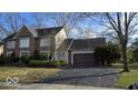 Attractive two-story brick home with a paved driveway and established landscaping at 7474 Oakland Hills Dr, Indianapolis, IN 46236