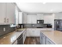 Modern kitchen featuring white cabinetry, stainless steel appliances, and a stylish island at 7710 Eagle Crescent Dr, Zionsville, IN 46077