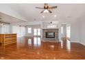 Spacious living room with laminate flooring, fireplace, and ceiling fan at 8417 Southern Springs Way, Indianapolis, IN 46237