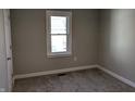Bright bedroom featuring neutral paint, carpet, and window at 101 N Gladstone Ave, Columbus, IN 47201