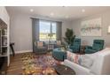 Bright living room with stylish furniture, a large window, and hardwood floors at 1014 Jackson St, Columbus, IN 47201