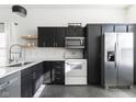 Stylish kitchen featuring sleek black cabinets, modern appliances, and a functional layout at 10478 Blue Springs Ln, Fishers, IN 46037