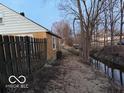 Property with a fenced boundary bordering a stream, offering both privacy and a natural setting at 133 Tripps Ave, Lebanon, IN 46052
