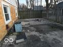 Fenced backyard with a mix of brick pavers and gravel, providing a private outdoor space at 133 Tripps Ave, Lebanon, IN 46052