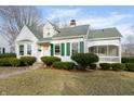 Charming home featuring white siding, green shutters, and a well-manicured lawn at 147 Eastern Ave, Plainfield, IN 46168
