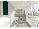 Cozy screened-in porch with white railings, ceiling fan, and table, perfect for relaxing at 147 Eastern Ave, Plainfield, IN 46168
