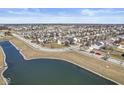 Wide aerial view of a residential neighborhood with a picturesque lake, showcasing the community's layout and landscaping at 15101 Proud Truth Dr, Noblesville, IN 46060