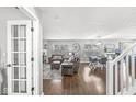 Bright living room with hardwood floors, a cozy seating area, and abundant natural light streaming through the windows at 15101 Proud Truth Dr, Noblesville, IN 46060