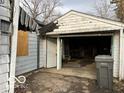 View of the detached garage, revealing its interior space and door at 1827 N Whittier Pl, Indianapolis, IN 46218
