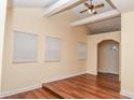 Bright living room with hardwood floors, a ceiling fan, and a doorway at 1937 N Lasalle St, Indianapolis, IN 46218