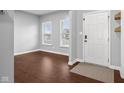 Bright foyer featuring hardwood floors, a white front door, and natural light at 2016 Woodland Parks Dr, Columbus, IN 47201