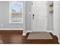 Inviting entryway featuring hardwood floors, natural light and decorative wall baskets at 2016 Woodland Parks Dr, Columbus, IN 47201