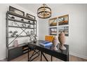 Stylish home office featuring a modern desk, decorative shelving, and unique light fixture, creating an inspiring workspace at 2165 Mildred Rd, Westfield, IN 46074
