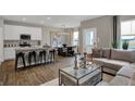 Open-concept living space with a modern kitchen island and breakfast bar seating at 2171 Mildred Rd, Westfield, IN 46074