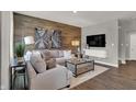 Comfortable living room featuring a wood-look accent wall, neutral furniture, and stylish decor at 2171 Mildred Rd, Westfield, IN 46074