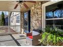 Cozy covered porch with wicker furniture, ceiling fan, and stone detailing, perfect for enjoying the outdoors at 265 Goodnight Rd, Martinsville, IN 46151