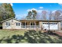 Inviting single-story home with stone accents, a cozy covered porch, and an attached two-car garage for added convenience at 265 Goodnight Rd, Martinsville, IN 46151