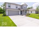 Charming two-story home with gray siding, a well-manicured lawn, and an attached two-car garage at 3328 Stafford St, Sheridan, IN 46069