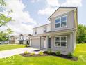 Charming two-story home with gray siding, a well-manicured lawn, landscaping, and attached two-car garage at 3328 Stafford St, Sheridan, IN 46069
