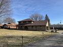 View of home showing walkway and driveway with manicured lawn and shrubbery at 3515 Beechwood Ln, Anderson, IN 46011