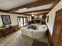 Living room with a stone fireplace, wood beams and beautiful neutral decor at 3515 Beechwood Ln, Anderson, IN 46011