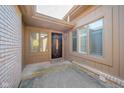 Inviting front entryway features a decorative front door, transom window, and sidelights for ample natural light at 3535 Woodglen Way, Anderson, IN 46011