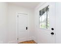 Bright, white foyer with natural light and hardwood floors at 3750 Totem Ln, Indianapolis, IN 46208