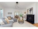 Elegant living room with a fireplace, modern lighting, and an open floor plan at 3750 Totem Ln, Indianapolis, IN 46208
