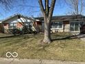 Well-maintained single-story home with a lush green lawn and mature trees at 424 Wayside Dr, Plainfield, IN 46168