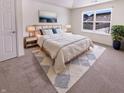 Bright bedroom with large window, neutral tones, and a plush area rug provides a serene retreat at 4943 Dunlin Dr, Indianapolis, IN 46235
