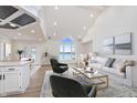 Bright living room featuring vaulted ceilings, a view of the water, and an open layout connecting the kitchen at 5004 Boardwalk Pl, Indianapolis, IN 46220