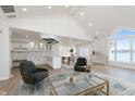 Bright living room featuring vaulted ceilings, a view of the water, and an open layout connecting the kitchen at 5004 Boardwalk Pl, Indianapolis, IN 46220