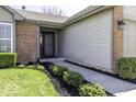 Close-up showcasing the entrance to this home featuring a landscaped walkway and brick accents at 5503 Thompson Park Blvd, Indianapolis, IN 46237